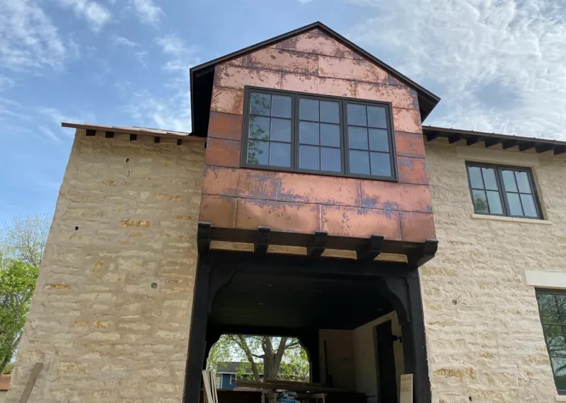 Copper metal panel facade on a stone building for Roof Repair in Marlow Heights